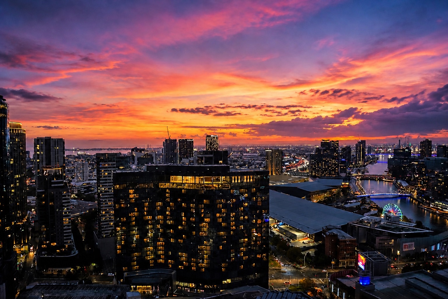 Living room of the Southbank apartment at dusk, with floor-to-ceiling windows over the Melbourne skyline